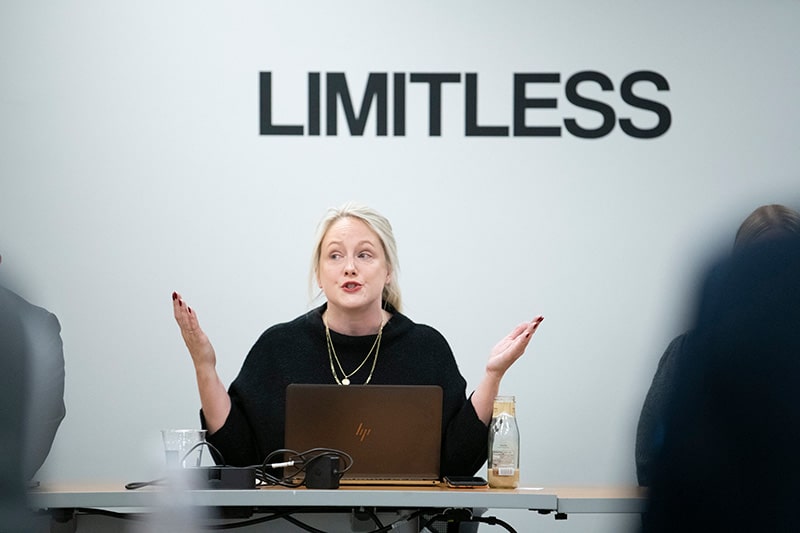 Meris Stansbury, in front of a sign that says "Limitless"